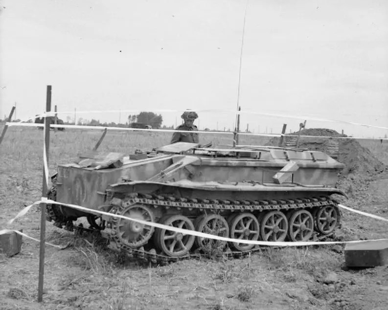 British soldier in Normandy with a captured Borgward IV remote-controlled explosive carrier vehicle